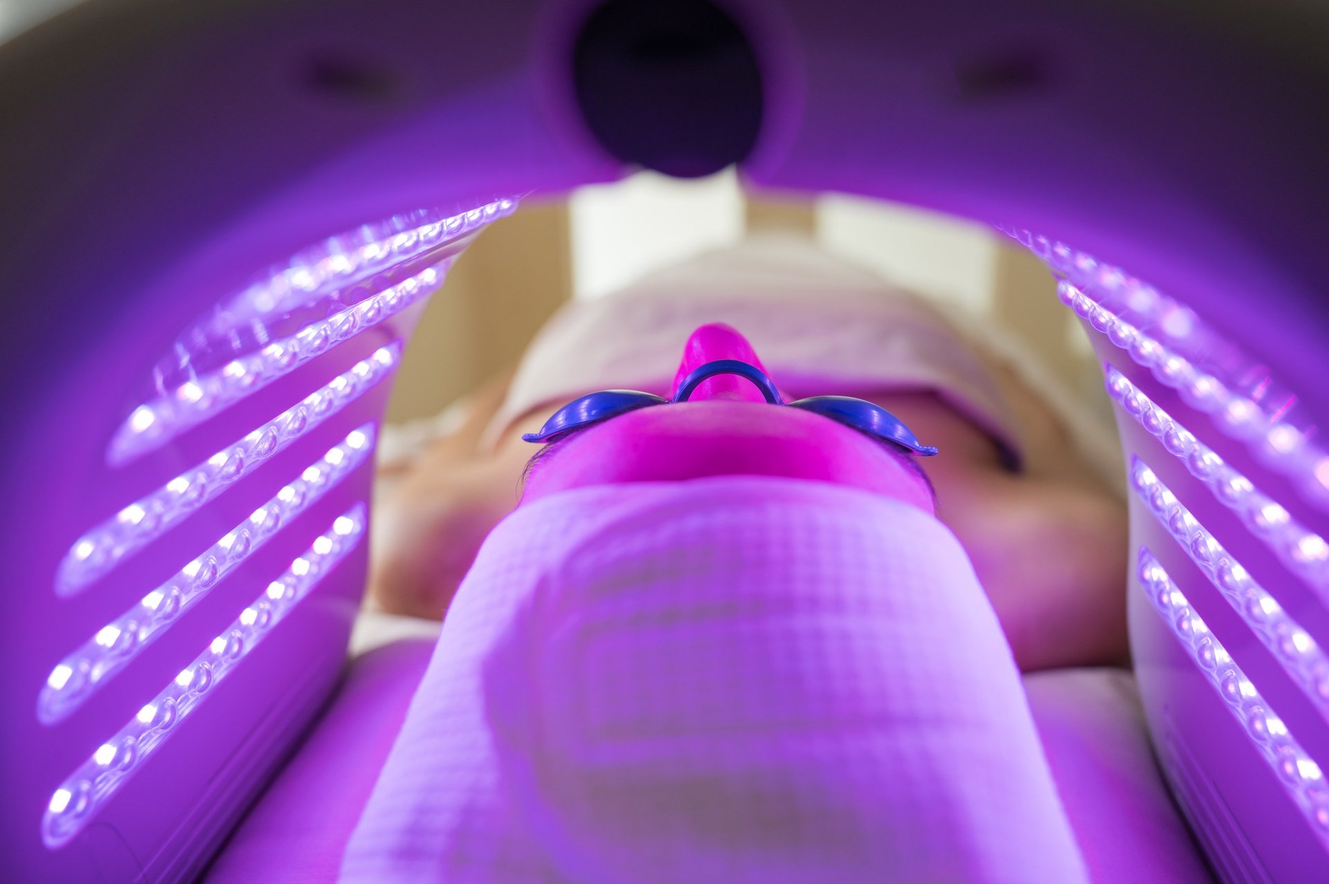 Woman receiving Hydradermabrasian LED light therapy treatment at a professional beauty salon