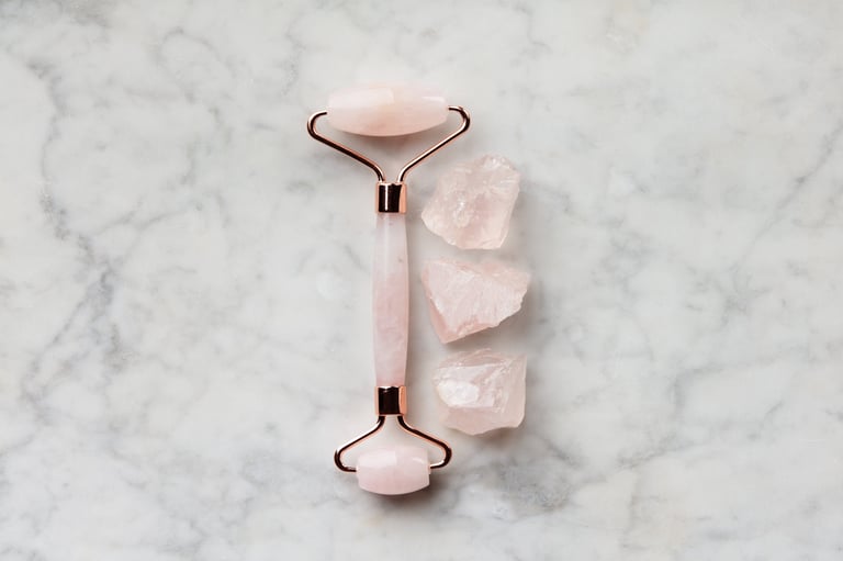 Premium rose quartz ice roller on white marble surface, luxury skincare tool for sensitive skin
