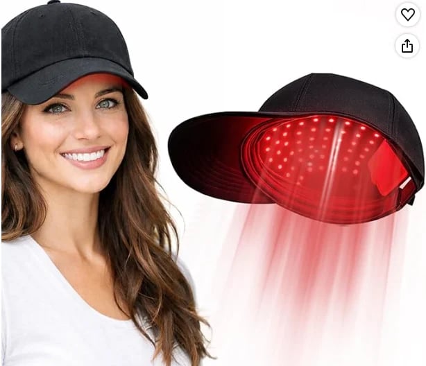 Woman wearing black baseball cap with red LED light therapy feature shown glowing underneath the visor